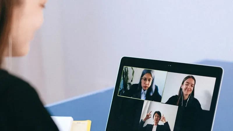 Person attending an online job interview on a laptop