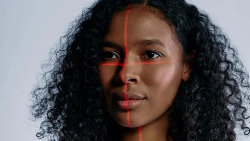Facial recognition scan lines overlaid on a portrait photo