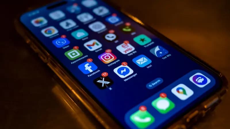 Close-up of a smartphone showing social media app icons