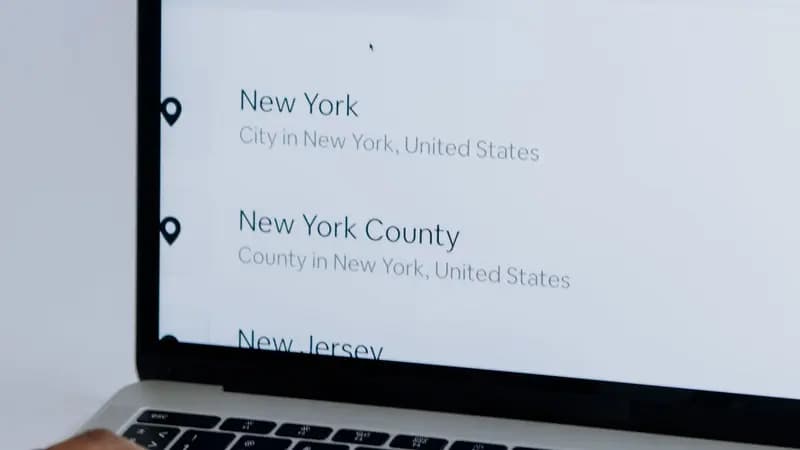 Person typing on a laptop with a search engine open