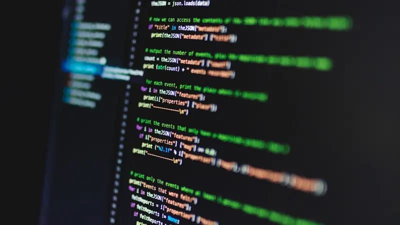 A laptop screen showing a code editor