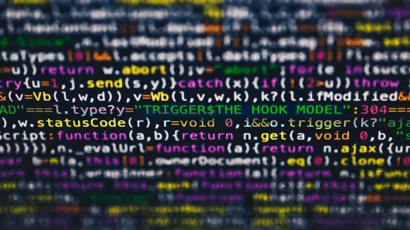 A laptop screen showing lines of code