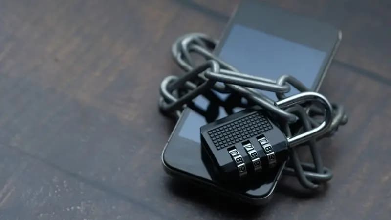 Close-up of a smartphone displaying a padlock indicating device encryption