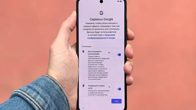 Hand holding a smartphone displaying a Google settings screen