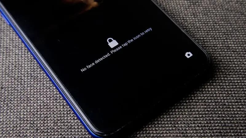 Close-up of a smartphone on a grey surface being checked for security
