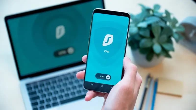 Smartphone and laptop both showing an active Surfshark VPN connection