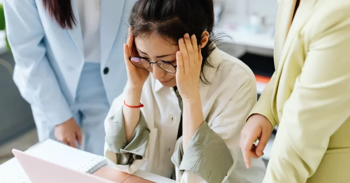 Woman looking worried and concerned at a laptop screen
