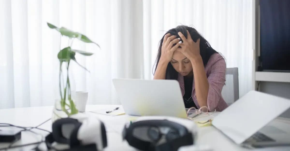 Woman looking stressed while working at a computer