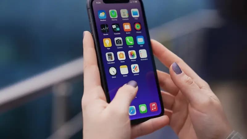 Someone tapping through the apps on their iPhone