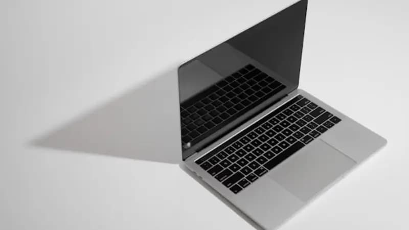 A clean MacBook on a white desk