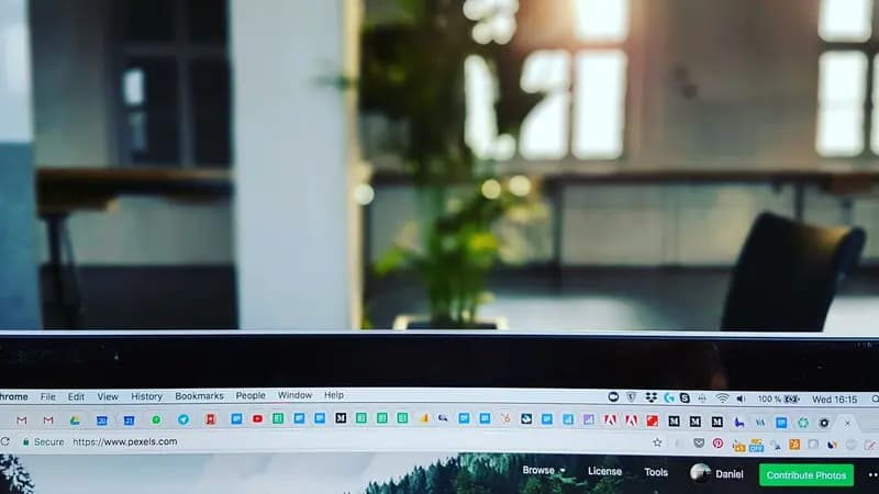 Person using a laptop with several browser tabs open