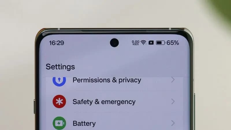 Close-up of an Android settings menu showing privacy and battery controls on screen