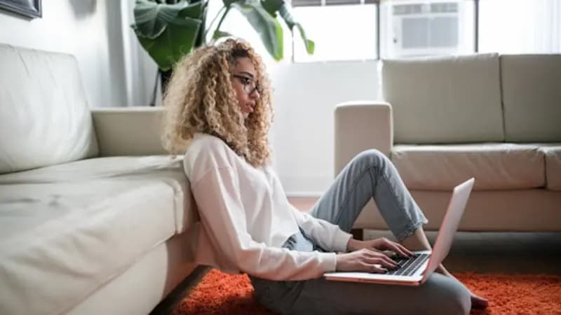 A person using a laptop at home